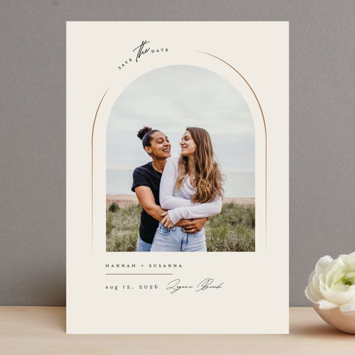 a white card with an image of two people hugging each other and the text save the date on it