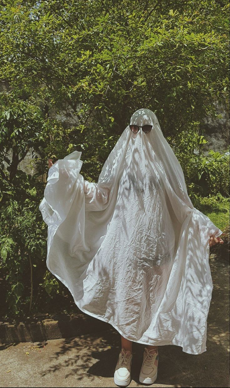 a person in a white dress and sunglasses