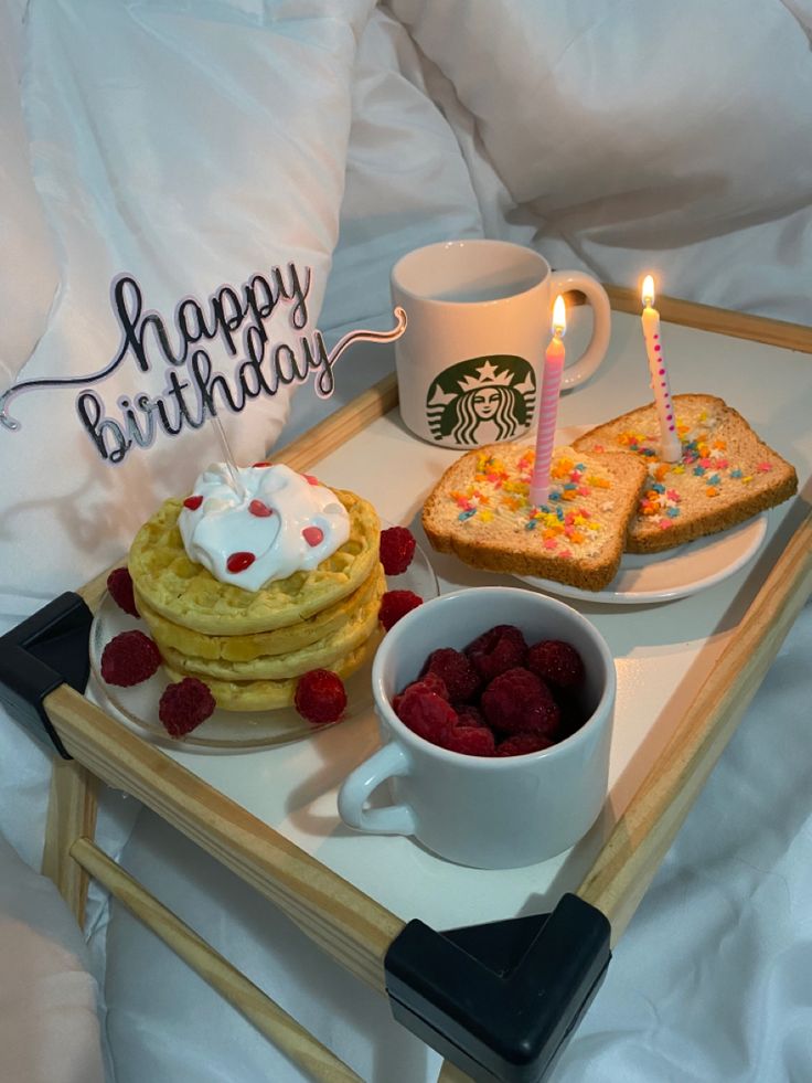 a tray with pancakes, raspberries and toast on it that says happy birthday