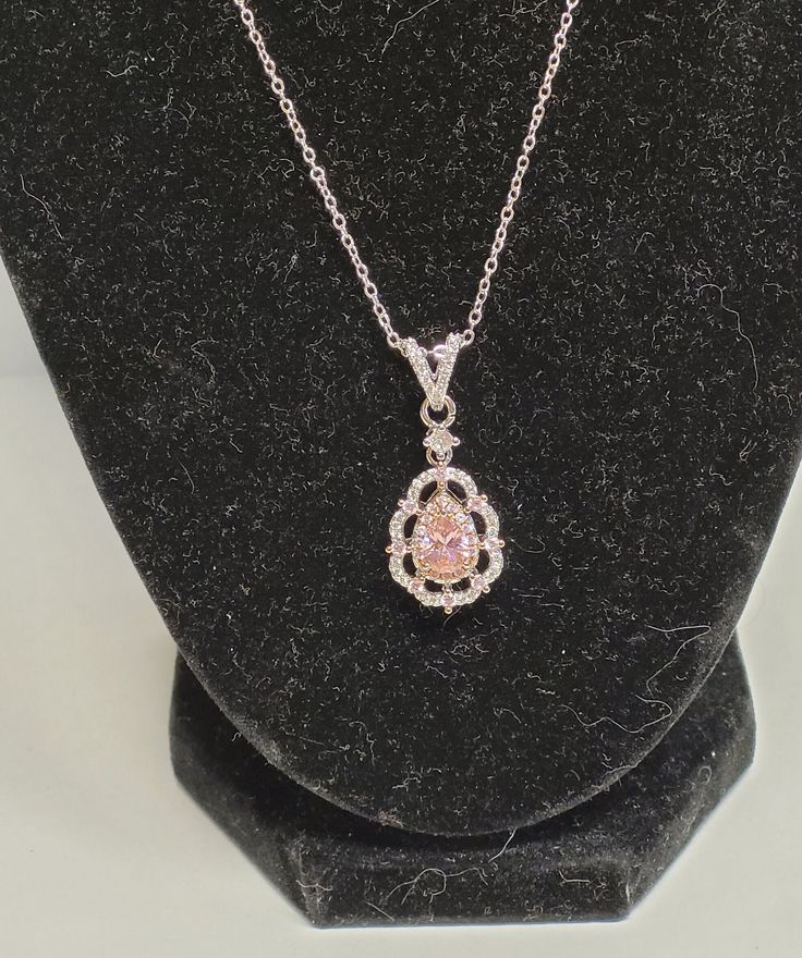 Jacob's jewel pink cubic zerconia necklace Width: 1 1/2cm Height: 3 1/2cm Chain length: 16in Dazzling Cubic Zirconia Teardrop Pendant Necklace, Pink Cubic Zirconia Rhinestone Necklace As Gift, Elegant Pink Diamond Necklace With Accents, Oval Crystal Necklaces With Diamond Accents, Oval Crystal Necklace With Diamond Accents, Pink Cubic Zirconia Flower Pendant Necklace, Oval Diamond White Cubic Zirconia Necklace, Pink Round Pendant Necklaces For Wedding, Pink Round Pendant Necklace For Wedding