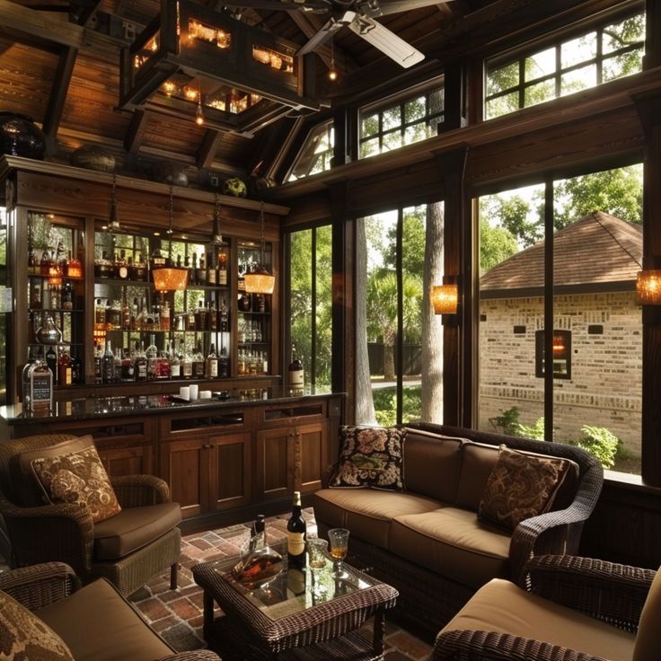 a living room filled with furniture and lots of windows next to a wall of bottles