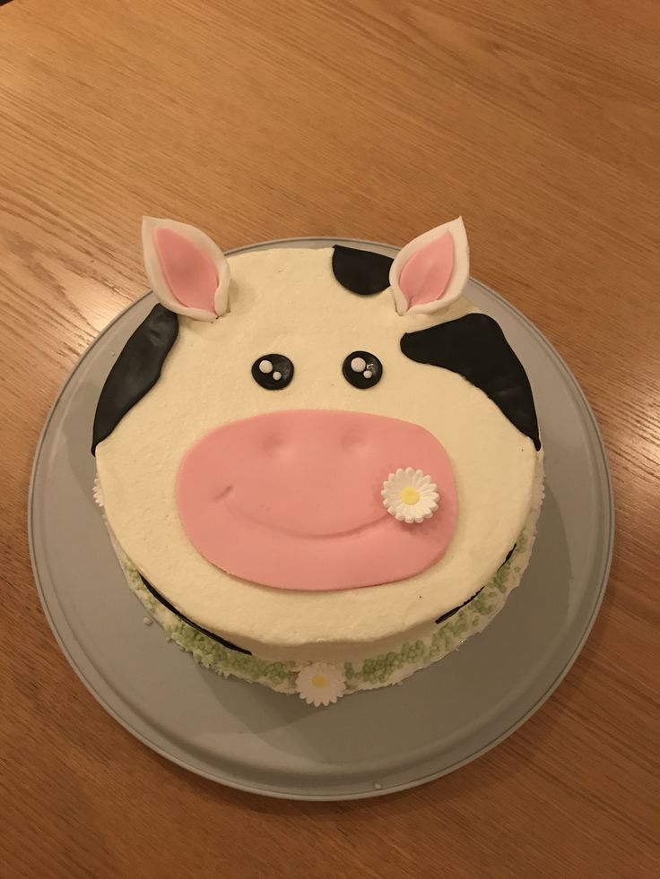 a cake shaped like a cow on top of a wooden table