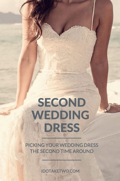 a woman in a wedding dress standing on the beach