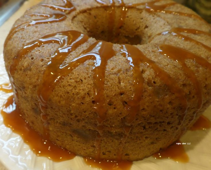 a close up of a cake on a plate with caramel drizzles