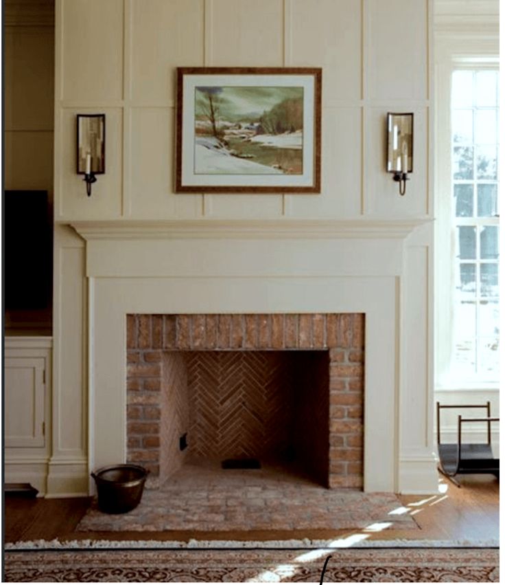 a living room with a fire place next to a window and a painting on the wall