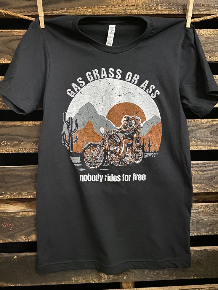 a black t - shirt with an image of a motorcyclist on it