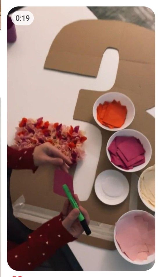 someone is painting the letters b and c with pink and orange paint on paper plates