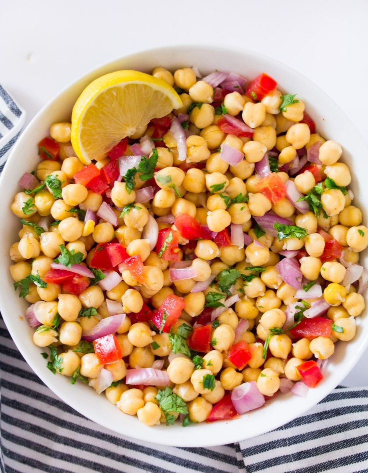 a white bowl filled with chickpeas, onions and cilantro