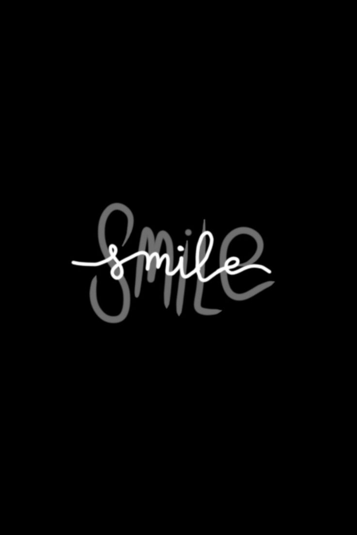 the word smile written in white ink on a black background