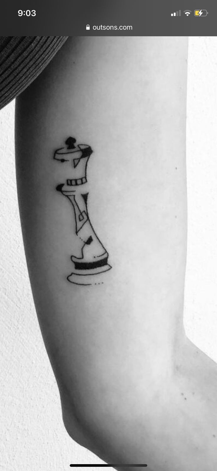 a black and white photo of a chess piece tattoo