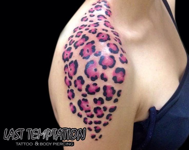 a woman's breast with pink and black leopard print on it