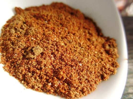 a white bowl filled with spices on top of a table