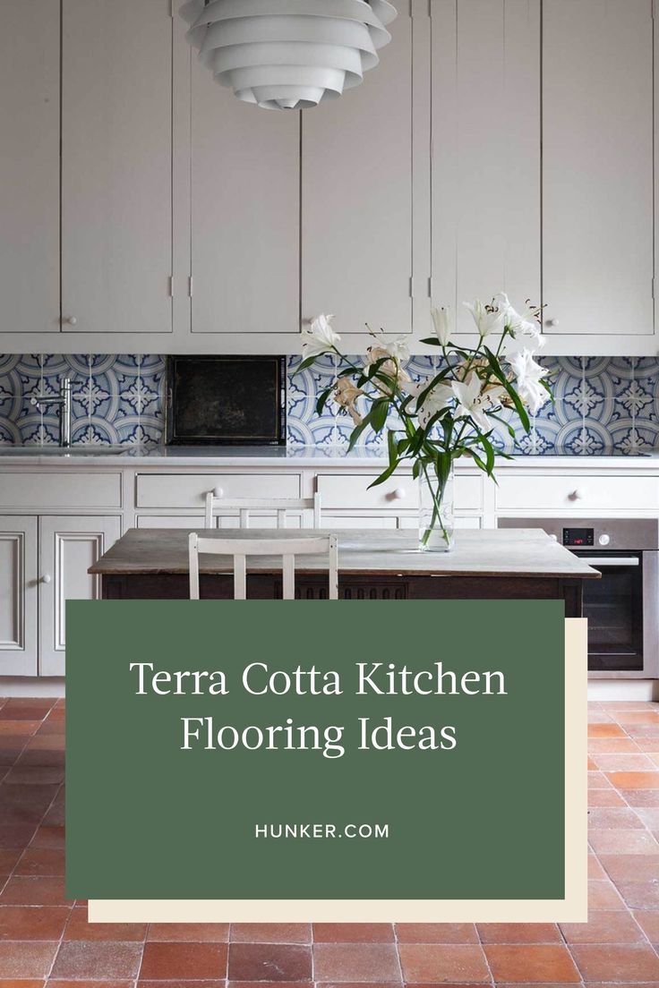 a kitchen with white cabinets and tile flooring in the center is a green sign that says terra cota kitchen flooring ideas