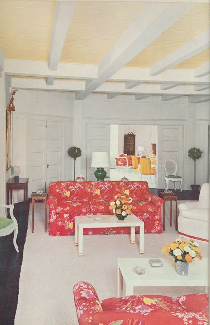 a living room filled with furniture and flowers