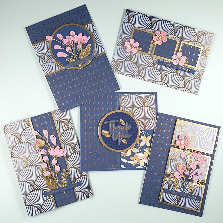 four blue and gold cards with flowers on them