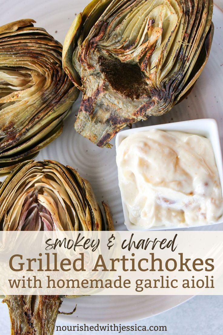 grilled artichokes with homemade garlic aioli on a white platter