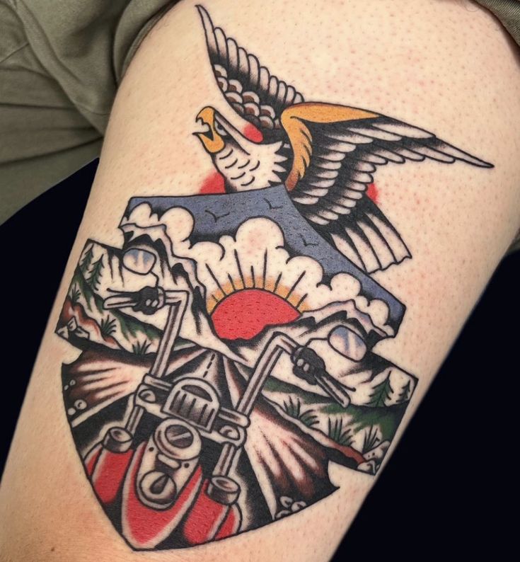 a tattoo on the arm of a person with a bird flying over it's head