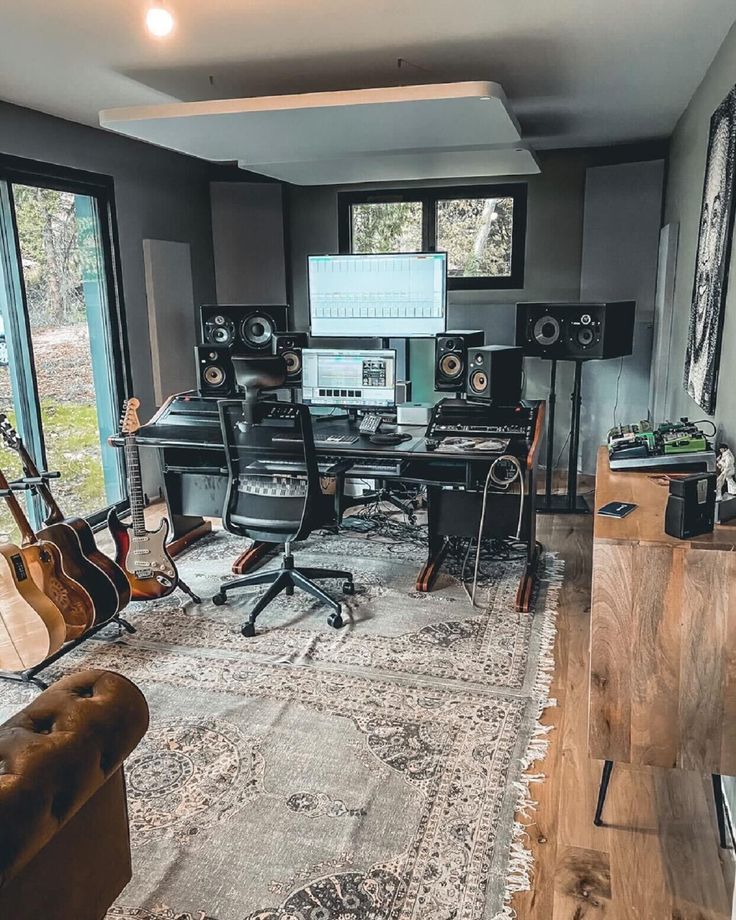 a living room filled with lots of furniture and musical equipment on top of a rug