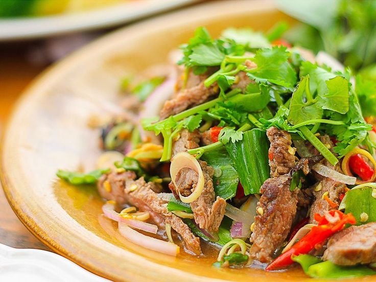 a close up of a plate of food with meat and veggies on it