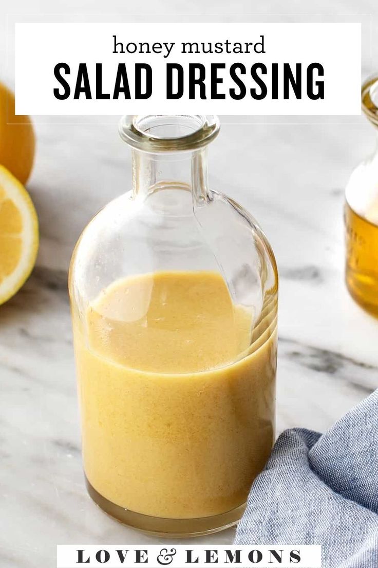 a glass bottle filled with liquid next to sliced lemons