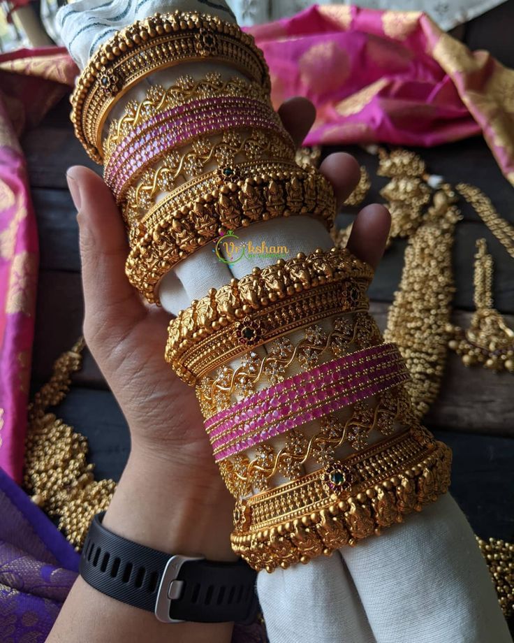 a person holding several bracelets in their hand