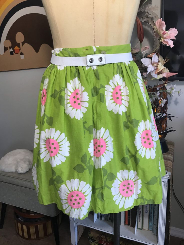 "Cute as can be! Apple green with whimsical flowers in white and neon pink. Attached white cotton and lace petticoat. Two tiny Frey's in fabric at the hem pictured. Easily repaired. Measurements: 26\" waist 42\" free flared hips 70\" circumference at hem 1-3/4\" waistband 7-1/2\" back nylon zipper with two button waist closure 19\" from top of the waistband to hem from the back" Cute Cotton Skirt With Floral Print, Spring Cotton Skirt For Garden Party, Summer Cotton Fitted Petticoat, Fitted Cotton Summer Petticoat, Fitted Cotton Petticoat For Summer, Fitted Green Skirt For Garden Party, Spring Retro Petticoat, Green Skirt For Spring Garden Party, Spring Garden Party Cotton Skirt