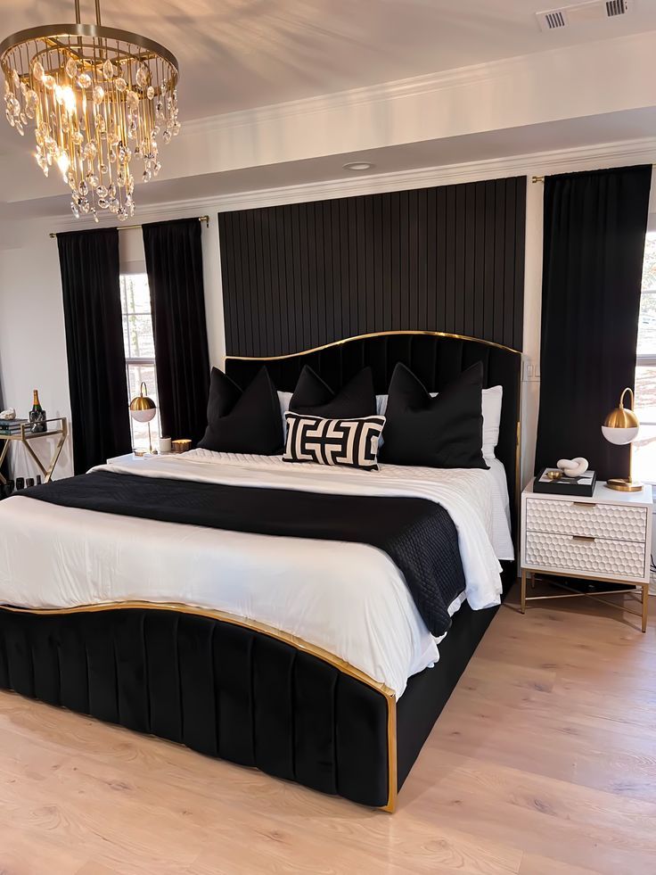 black & gold bed frame, unique asymmetrical bed frame, black throw pillows, black curtains, white bedding, modern bedroom style Black Gold Bed Frame, Black Bedroom Decor Beds & Frames, Room Decor With Black Bed Frame, White And Black Interior Design Bedroom, Black And Gold Aesthetic Bedroom, Gold And Black Bedroom Decor Ideas, Black And Gold Bed Frame, Black And White Gold Bedroom Ideas, Black Bed With White Furniture