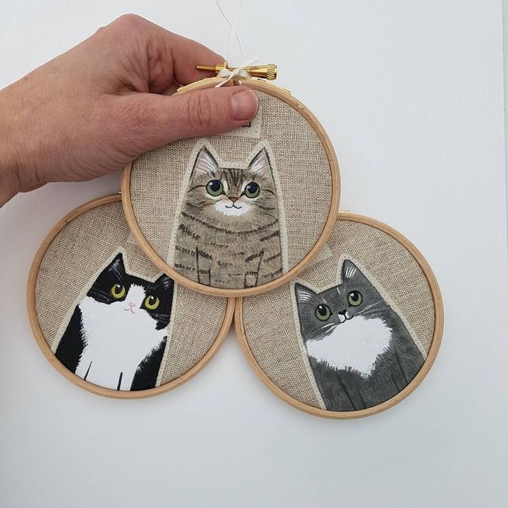 three hand embroidered coasters with cats on them