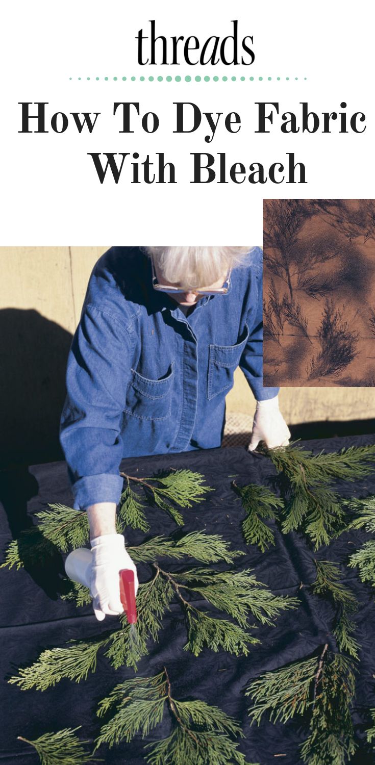 a person in overalls and white gloves working on a piece of fabric with pine needles