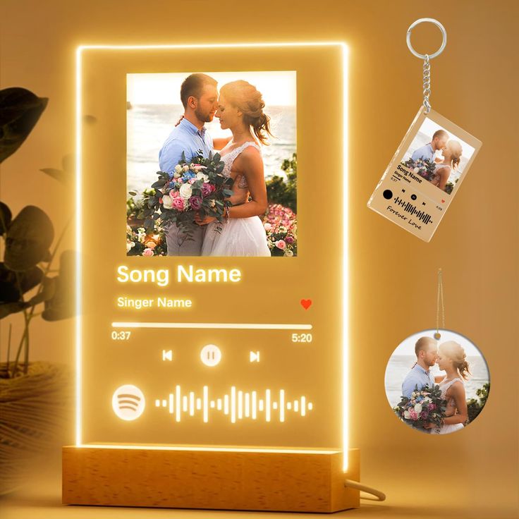 an illuminated photo frame with a keychain attached to it and two personalized photos