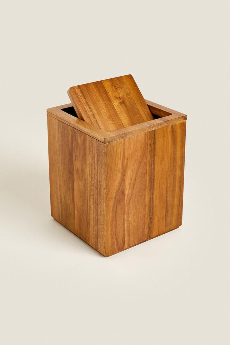 a wooden box with a knife in it