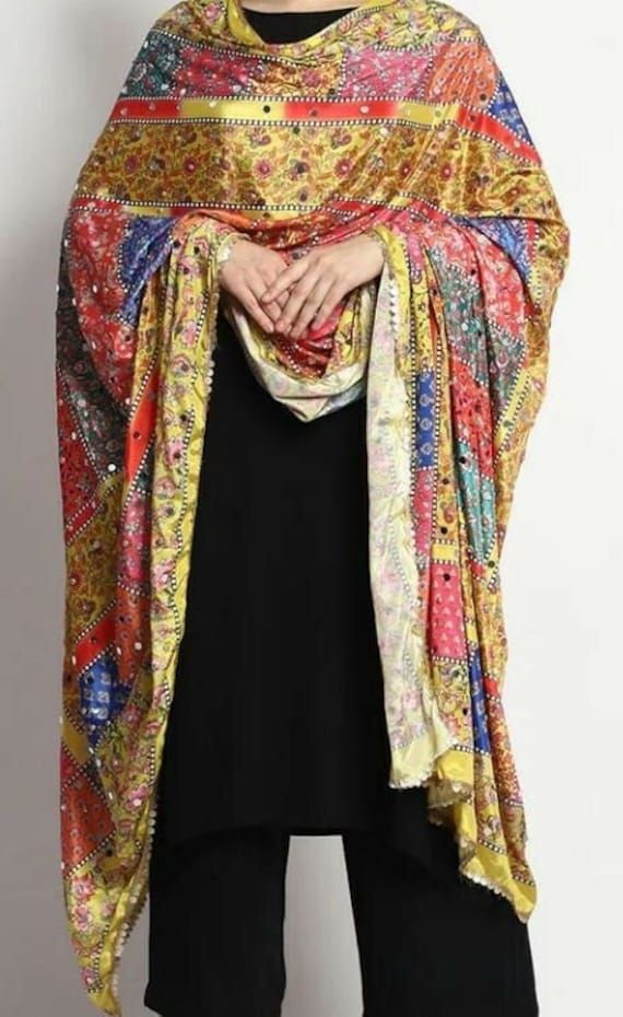 Welcome! Introducing our Punjabi Multicolored digital printed chiffon blended dupatta a stunning and vibrant accessory that celebrates the rich cultural heritage of Punjab, India. This traditional embroidered shawl is a true work of art, featuring intricate and colorful designs that are sure to make a statement wherever you go. Heavy handwork of mirrors and shimmers Multicolored geometric and floral pattern The bright and bold colors of the embroidery make this dupatta a perfect accessory to bri Embroidered Shawl, Phulkari Dupatta, Winter Wrap, Cashmere Pashmina, Bridal Shawl, Long Frocks, Chiffon Dupatta, Pakistani Bridal, Mirror Work