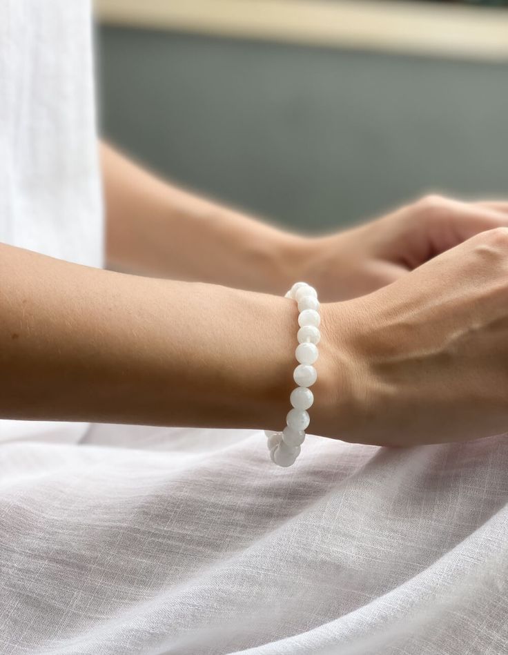 The moonstone bracelet for love is the perfect way to attract positive energy and loving vibes into your life. The beautiful beaded bracelet is made with natural moonstone gemstones, which have been believed to possess powerful healing properties for centuries. Wear the bracelet as a symbol of your own love and light, and enjoy the peace and serenity it brings you. Crystal Bracelet Photography, Elegant Crystal Gemstone Bracelet For Meditation, Elegant Crystal Bracelet With 8mm Beads, Elegant Adjustable Gemstone Beads Crystals, Hand-strung Moonstone Beaded Bracelets For Meditation, Spiritual Hand-strung Moonstone Bracelets, Elegant Rose Quartz Crystal Bracelet For Meditation, Elegant White Beaded Bracelets With 8mm Beads, Elegant White Rose Quartz Crystal Bracelet