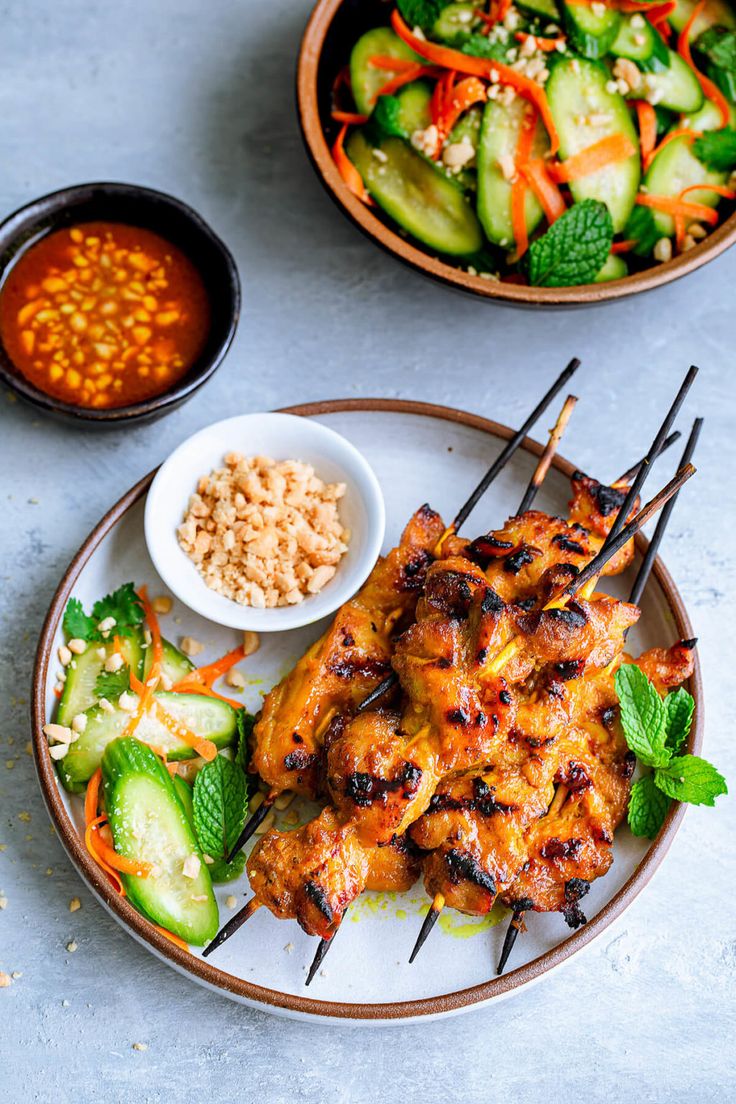 grilled chicken and vegetables on skewers with dipping sauce