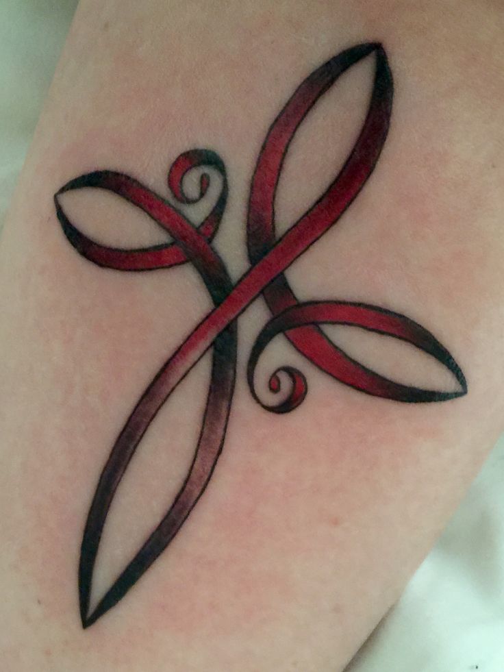 a red ribbon tattoo on the leg