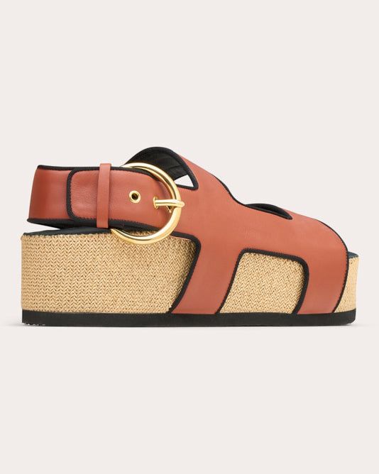 Casually luxe, the Cher sandal features a double-strap design crafted from genuine calf leather and set atop a raffia platform sole. Contrast grosgrain piping and shiny goldtone buckles offer elevated appeal. Goldtone buckle closure Contrast grosgrain piping Upper: 100% calf leather Contrast: 100% viscose Lining: 100% goat leather Platform: 100% raffia Outsole: 100% TRU Spot clean Handmade in Italy Size & Fit Platform height: 1.97in (50mm) Sustainability Metrics: Circular Economy: product is int Luxury Calf Leather Sandals With Rectangular Buckle, Calf Leather Double Strap Sandals With Buckle, Calf Leather Double Strap Sandals With Buckle Closure, Double Strap Calf Leather Sandals With Buckle Closure, Calf Leather Slingback Sandals With Tang Buckle, Leather Platform Slingback Footbed Sandals, Brown Double Strap Platform Sandals, Leather Platform Footbed Sandals With Open Heel, Calf Leather Slingback Sandals With Buckle Closure