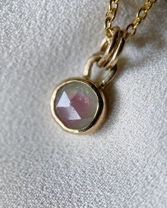 Mail carriers are currently experiencing high shipment volumes which may result in delays in delivery, so please note that at this time delivery times are not guaranteed. Thank you for your understanding and kindness.___________________A one of a kind watermelon tourmaline is the star of this sweet and simple charm necklace handcrafted in 14k yellow gold and sterling silver. The gorgeous tourmaline is bezel set in a two-toned setting: the bezel wall is solid 14k yellow gold and the open backing Gold Tourmaline Birthstone Jewelry, Dainty Gold Tourmaline Jewelry, Faceted Tourmaline Necklace Perfect As A Gift, Faceted Tourmaline Necklace For Gift, Round Tourmaline Birthstone Necklace, Dainty Tourmaline Gemstone Jewelry, Gold Tourmaline Jewelry With Bezel Setting, Yellow Gold Tourmaline Jewelry For May Birthstone, Tourmaline Birthstone Necklace