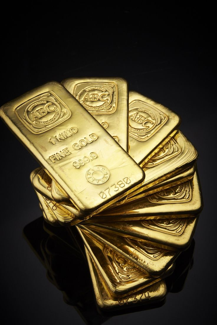 five gold bars stacked on top of each other in the middle of a black background