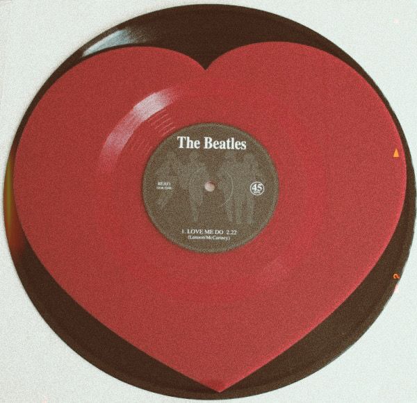 a red heart shaped record with the beatles on it