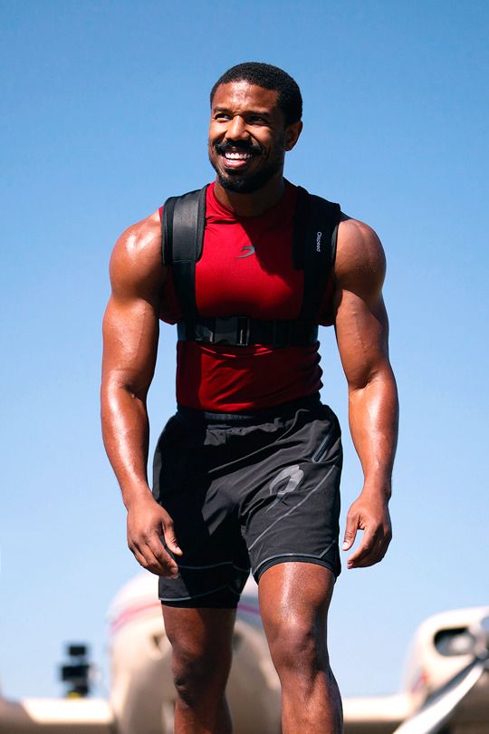 a man in red shirt and black shorts on skateboard