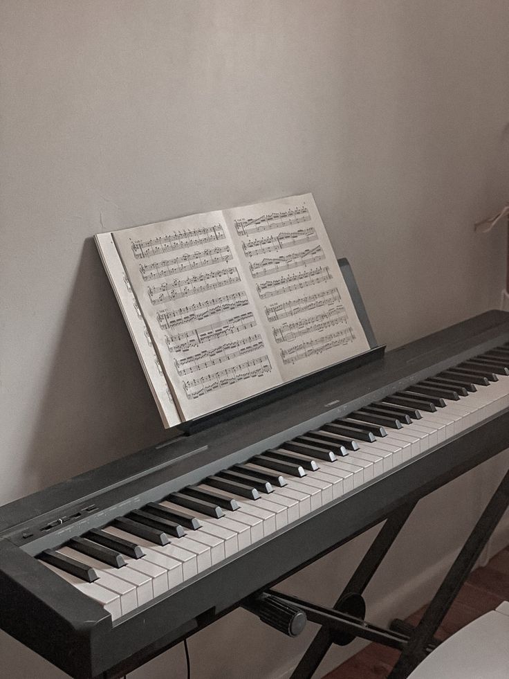 an open book sitting on top of a piano