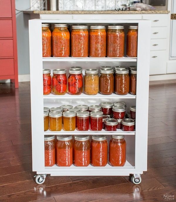 an organized spice rack in the middle of a kitchen with lots of jars on it