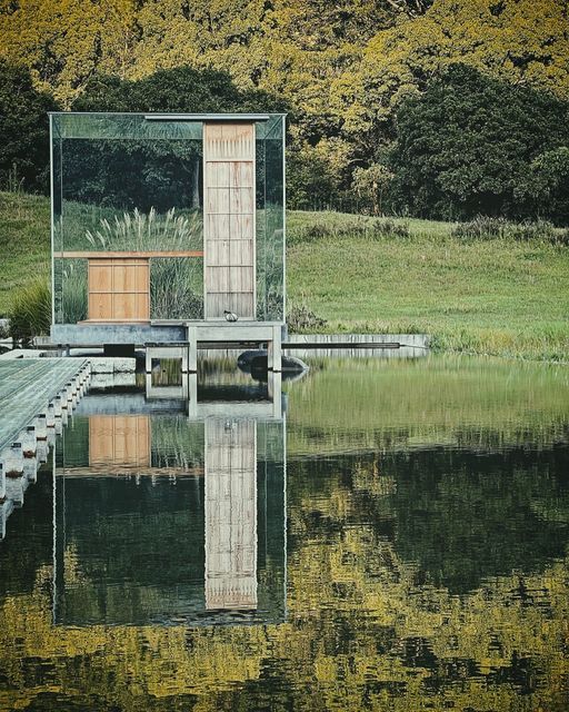 a wooden bench sitting on top of a body of water