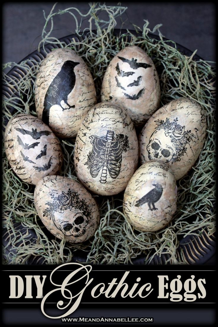 an image of painted eggs in the nest with birds on them for halloween decorating