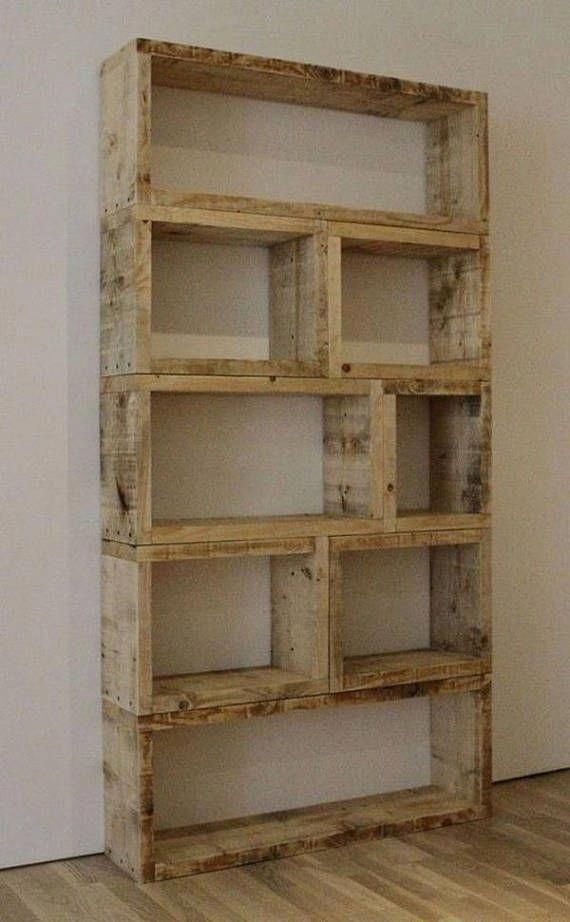 an empty wooden shelf sitting on top of a hard wood floor next to a white wall