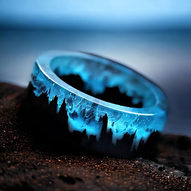 ✨ Elevate Your Style: Enchanting Blue Resin Ring with Wooden Mountains ✨ -Immerse yourself in the magic of this unique resin ring, a wearable piece of art that transports you to a tiny landscape within. Perfect for both women and men, this ring features wooden mountains embedded in captivating blue resin, creating a whimsical and punk-inspired piece with a touch of fantasy. 🔗 Key Features: -Magical Blue Resin: The enchanting blue resin captures a mesmerizing world within the ring, adding a touch of magic to your everyday style. -Wooden Mountains Inside: Delicately crafted wooden mountains are intricately placed within the resin, creating a tiny landscape that tells a unique story. -Unique for Women and Men: Versatile and unisex, this ring is designed to make a statement on any finger, mak Secret Wood Rings, Tiny Landscape, Cool Rings For Men, Mountain Ring, Magical Jewelry, Punk Jewelry, Resin Ring, Natural Scenery, Unisex Ring