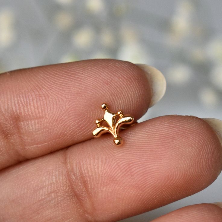 "Inspired from the beautiful Mughal motifs, this gold floral stud is a perfect piece for all your piercings. Crafted in 14k solid gold, this one of a kind pin makes for a great gift for a piercing lover and your loved ones. Great for your tragus, lobe, conch, helix, flat piercing. It also makes for a mesmerizing nose jewelry. * Dimension : 7x7mm (approx.) * Material : 14k Solid Gold If you like this stud, please press \"Pin it\" button on the top of your screen. Follow us on Instagram : @abhikaj Delicate Gold Cartilage Earrings, 14k Yellow Gold Cartilage Earrings For Gift, 14k Yellow Gold Cartilage Earrings, Elegant Nose Studs For Gift, Elegant Internally Threaded Yellow Gold Nose Studs, Dainty Gold Cartilage Earrings As A Gift, Elegant Gold Nose Studs As Gift, Gold Nose Studs For Wedding, Elegant Hypoallergenic 14k Gold Nose Rings