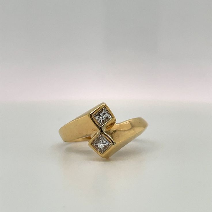 This ring is a simple Retro Design to symbolize Love & Friendship. Would make a great Engagement ring for the bride who does not prefer traditional single center stone ring. Details: Size: The ring is a Size 6. ( can be sized upon request) The stones are: 2 Princess cut Diamonds, Bezel set, G color VS2 clarity. .33ct total. Metal: 14K yellow gold The band tappers from 3.47 to 5.17mm. Every Antique piece of jewelry we sell at Heirloom Pavé has been checked for safety of each prong and repaire Fine Jewelry Bypass Ring With Tension Setting For Promise, Timeless Gold Bypass Ring For Wedding, Timeless Gold Bypass Wedding Ring, Diamond White Open Couple Rings For Anniversary, Diamond Bypass Ring With Tension Setting As Gift, Princess Cut Diamond Ring With Tension Setting For Promise, Fine Jewelry Anniversary Bypass Ring With Open Band, Promise Ring With Single Diamond And Open Design, Gold Bypass Ring With Prong Setting For Wedding