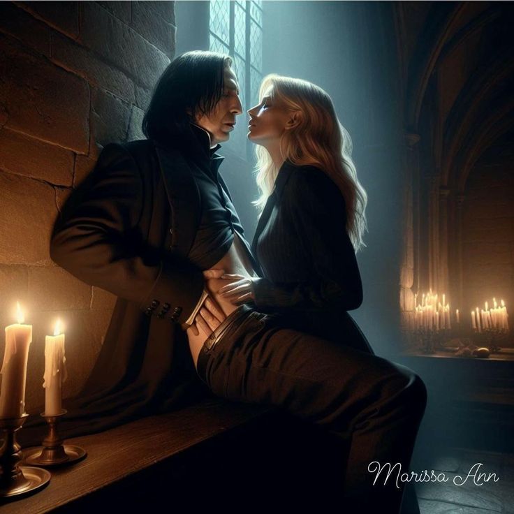 a man and woman sitting next to each other in front of candles