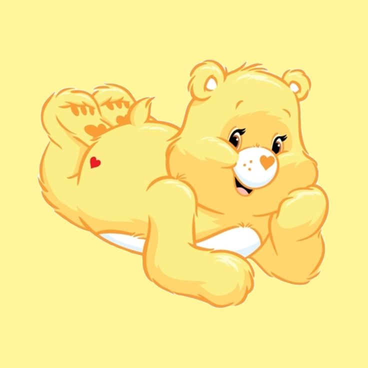 a yellow teddy bear laying on its back